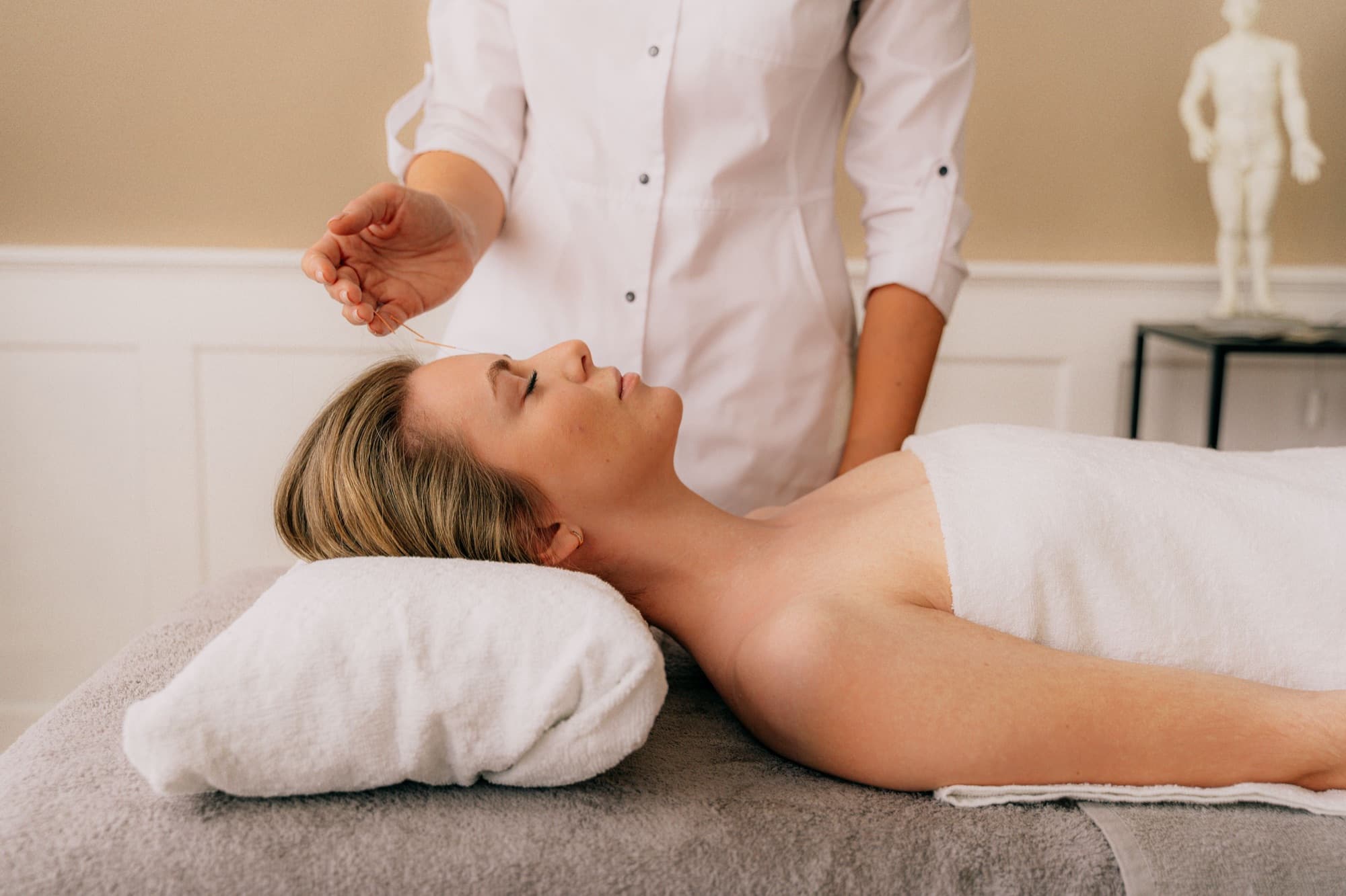 A client relaxing during an acupuncture session
